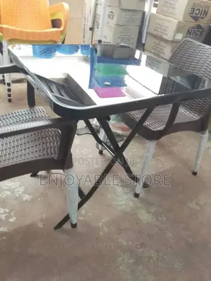 A Plastic Set of Two Chairs and Foldable Table