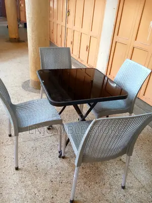 Armless Plastic Chairs and Glass Table Set