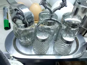 A Set of Sugarbowl Salt Shaker and Honey Dispenser