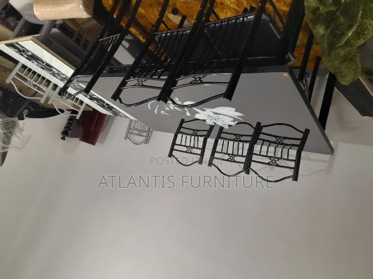 A Black Daining Table With Steel Legs.