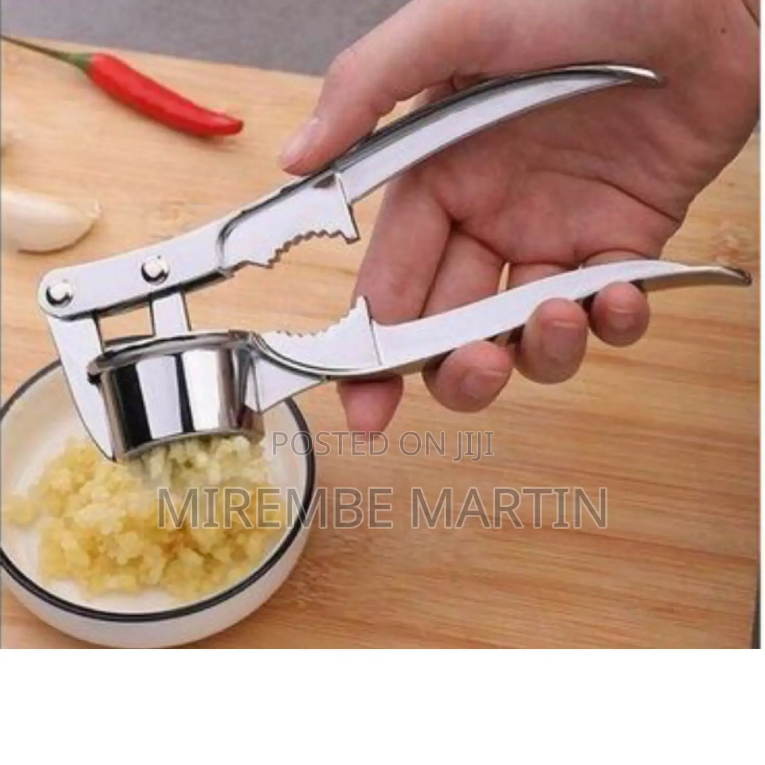 Round Stainless Steel Garlic Press.