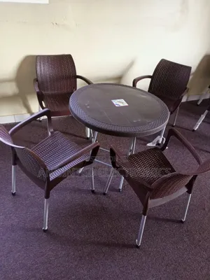 A Set of Plastic Table With Four Chairs