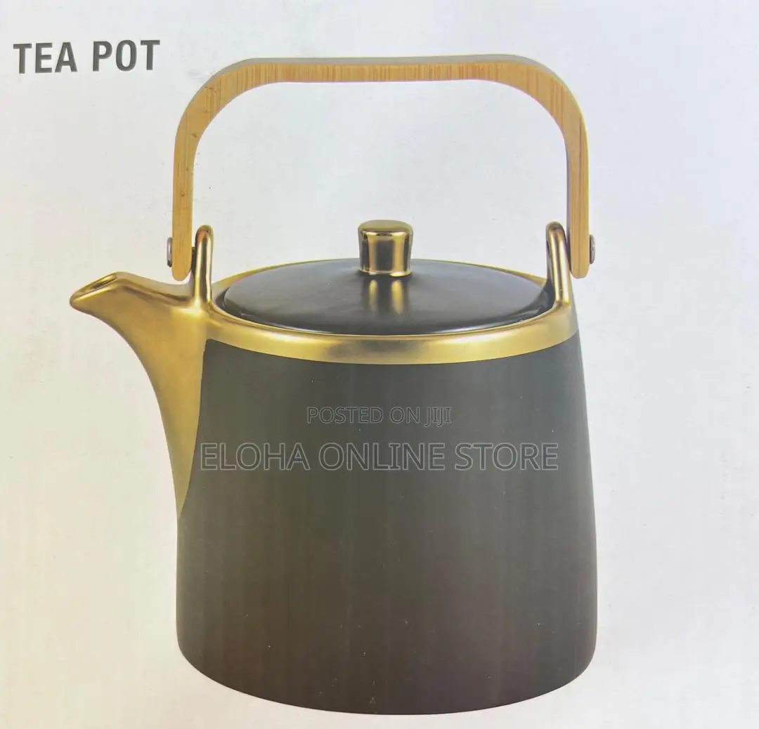 Gold Coated Tea Pot With a Wooden Handle
