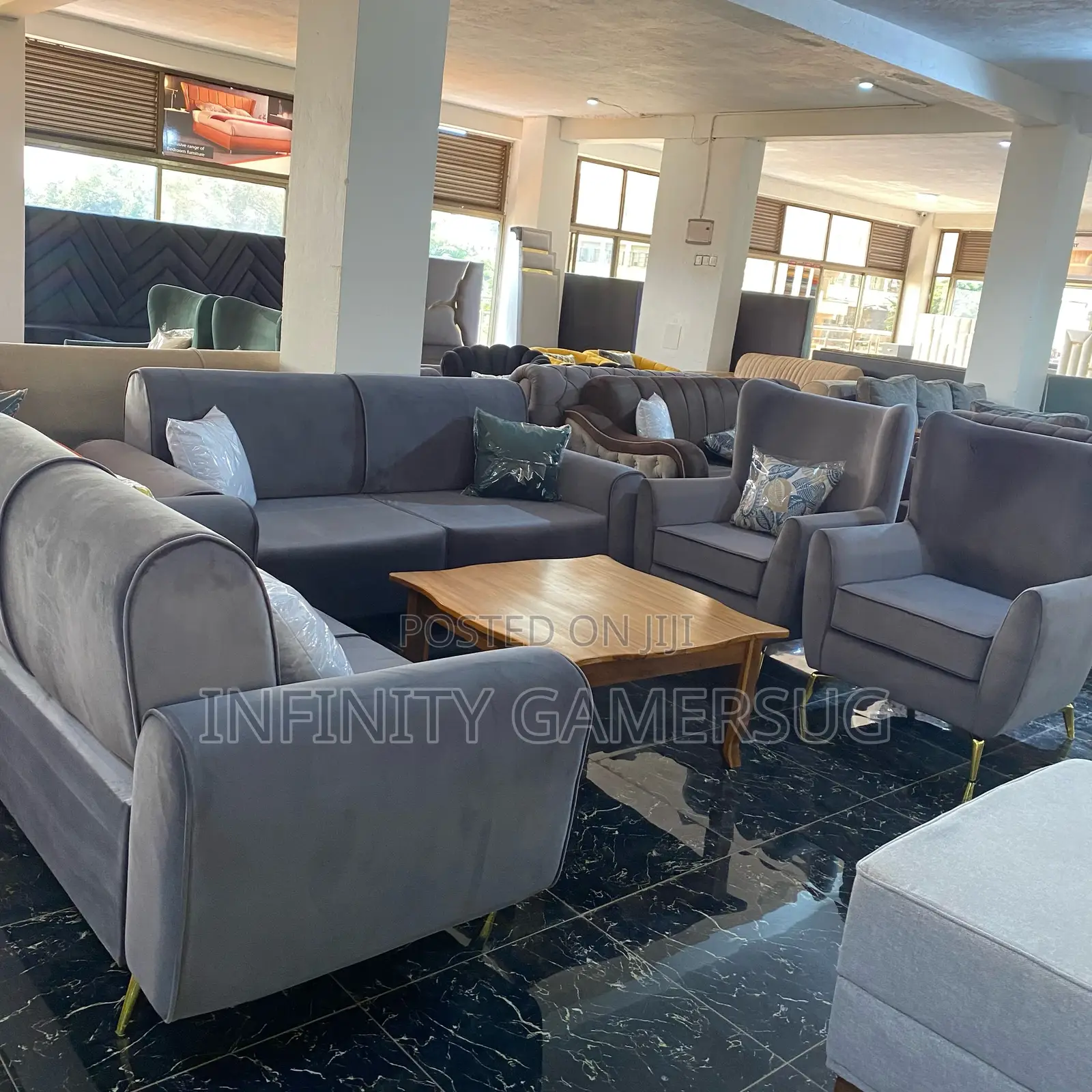 Classy Grey Sofa Made of Good Timber,Having Metallic Stands.