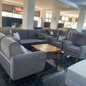 Classy Grey Sofa Made of Good Timber,Having Metallic Stands.