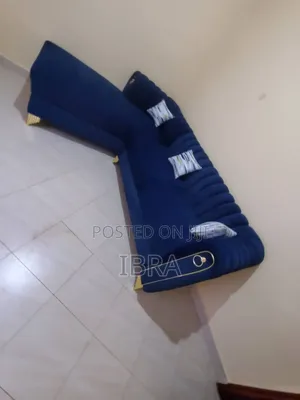 A Blue Lsofa Set With a Golden Stips