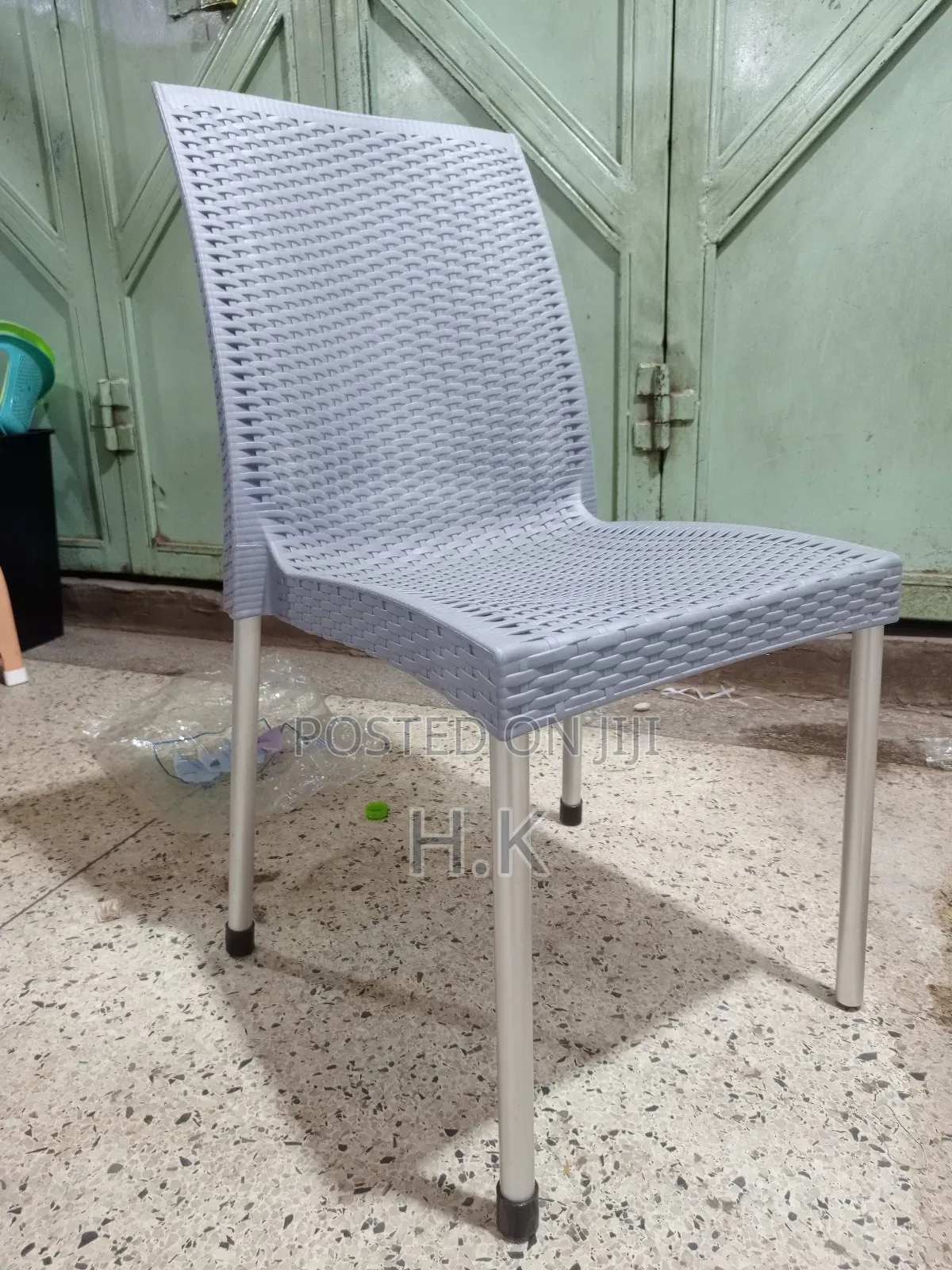 Plastic Chair With a Woven Design and Metal Legs.