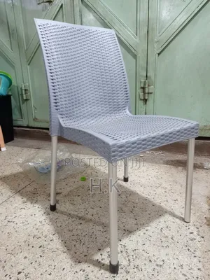 Plastic Chair With a Woven Design and Metal Legs.
