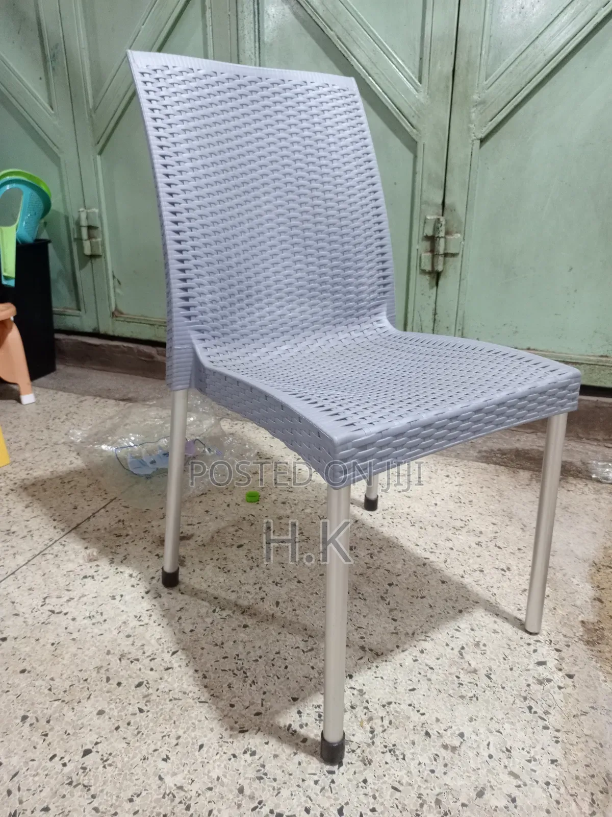 Plastic Chair With a Woven Design and Metal Legs.