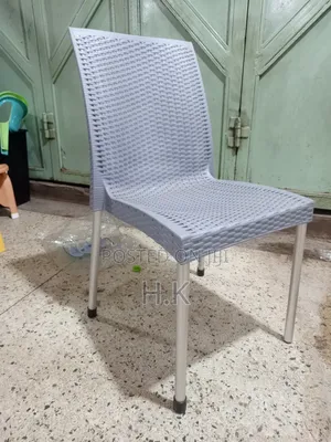 Plastic Chair With a Woven Design and Metal Legs.