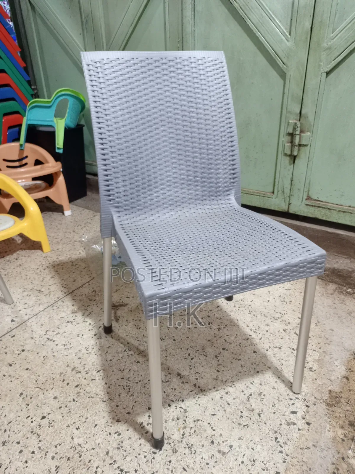 Plastic Chair With a Woven Design and Metal Legs.