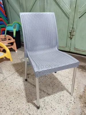 Plastic Chair With a Woven Design and Metal Legs.