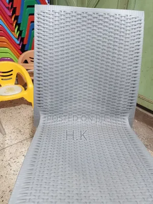 Plastic Chair With a Woven Design and Metal Legs.