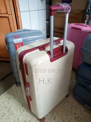 Beige Hard-Shell Suitcase With Spinner Wheels.