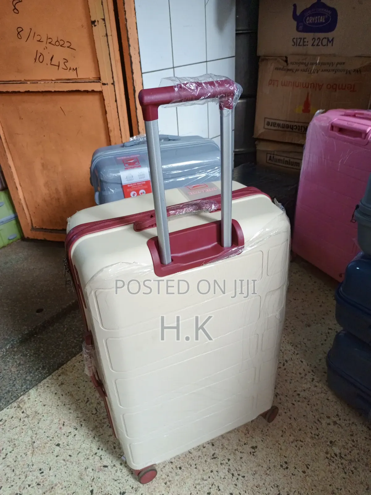 Beige Hard-Shell Suitcase With Spinner Wheels.