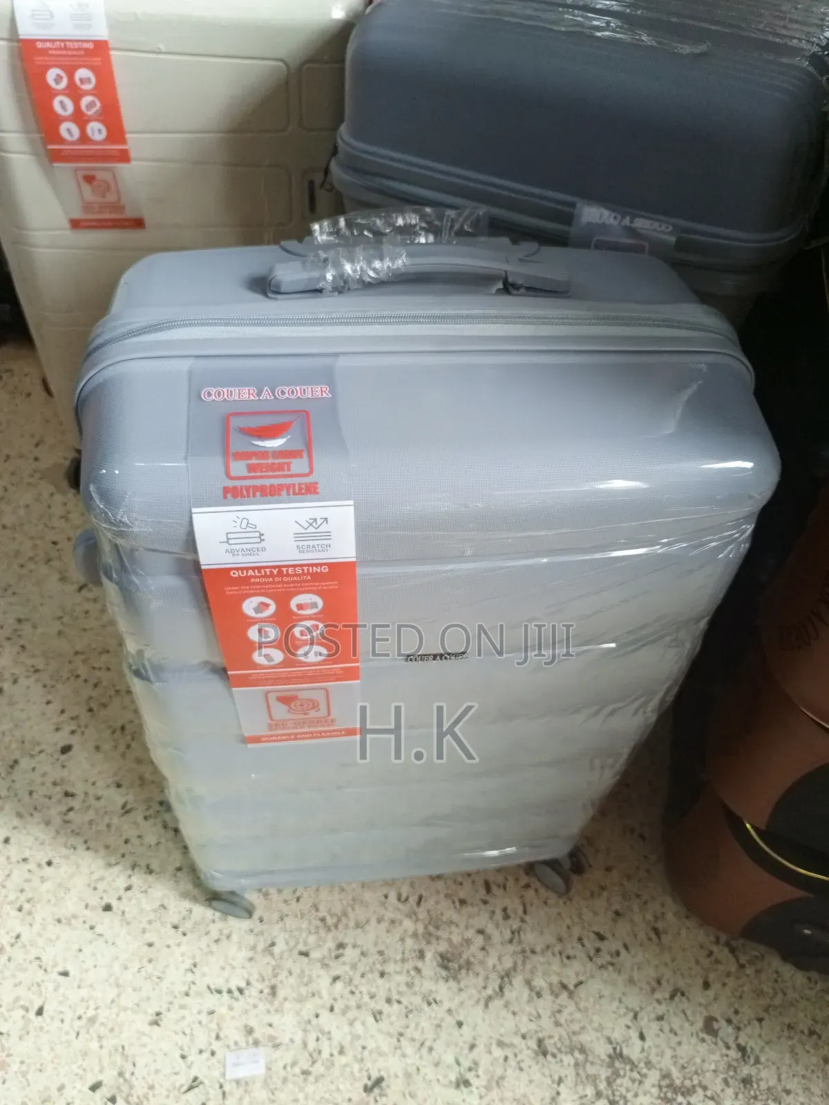 Beige Hard-Shell Suitcase With Spinner Wheels.