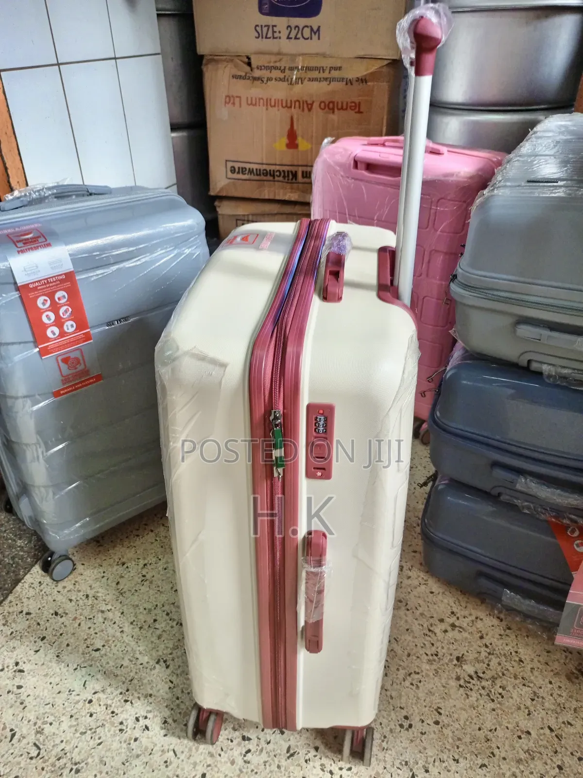 Beige Hard-Shell Suitcase With Spinner Wheels.