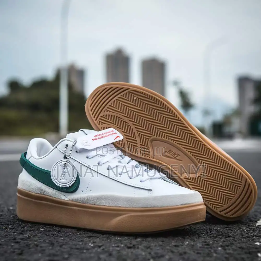 White Nike Sneaker With Green Design