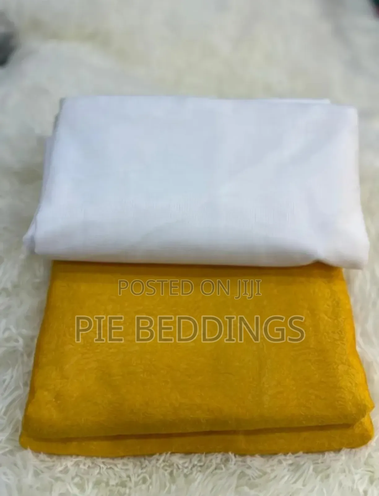 Pair of Yellow Curtains With a Net