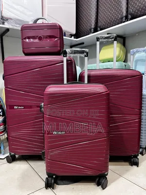 Plastic Red Maroon Travel Suitcases.