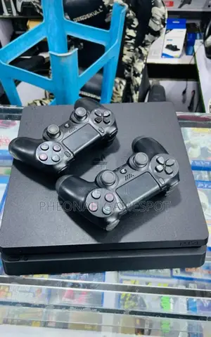 Playstation 4 Slim at Only 850000. With 14 Games and 2 Pads
