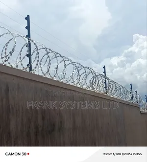 Electric Fence System With Razorwire on Residential House