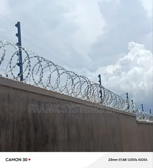 Electric Fence System With Razorwire on Residential House