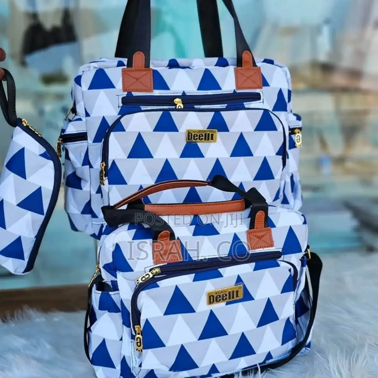A Set of Baby Diaper Bags With a Blue, White, and Gray