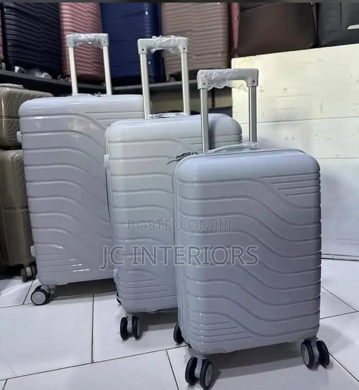 A Set of 3 Grey Rubber Suit Cases