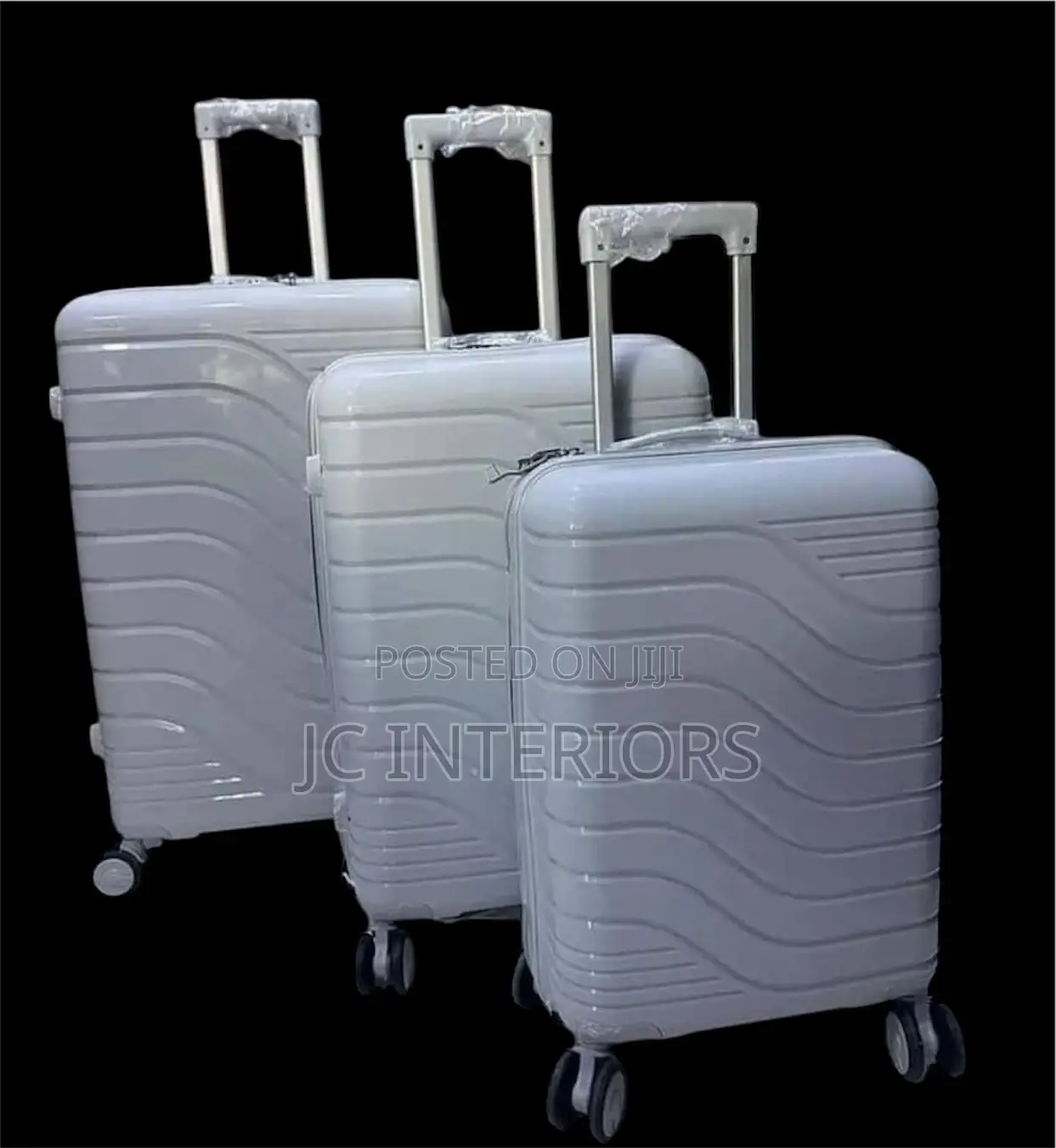 A Set of 3 Grey Rubber Suit Cases