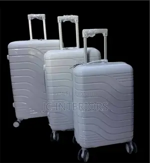 A Set of 3 Grey Rubber Suit Cases