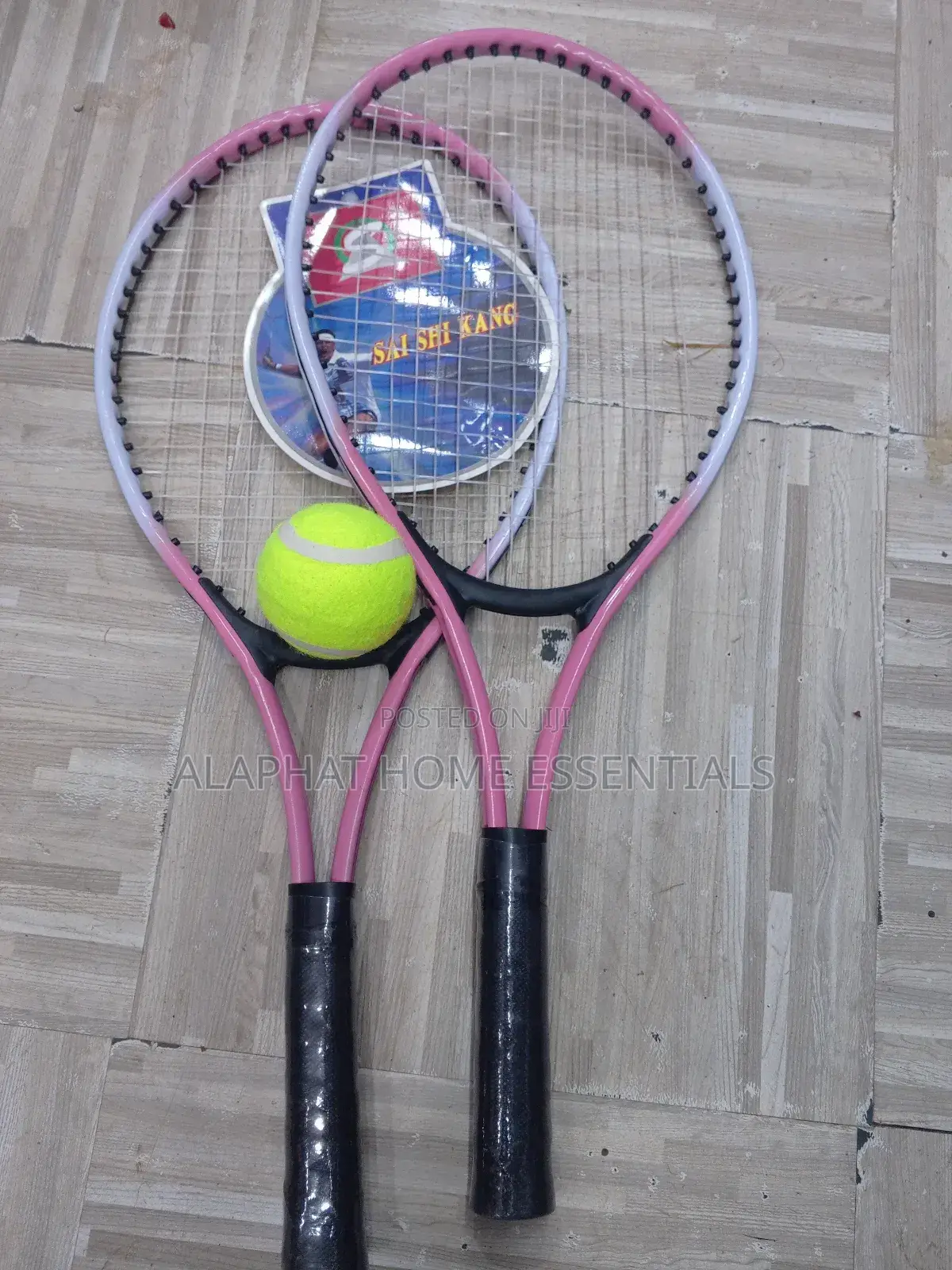 A Set of Tennis Racket With a Tennis Ball