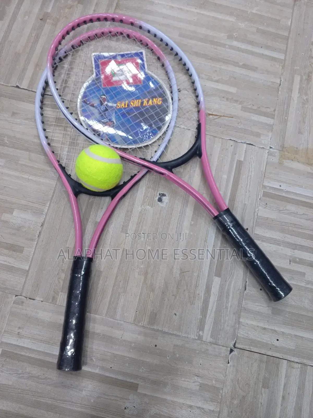 A Set of Tennis Racket With a Tennis Ball
