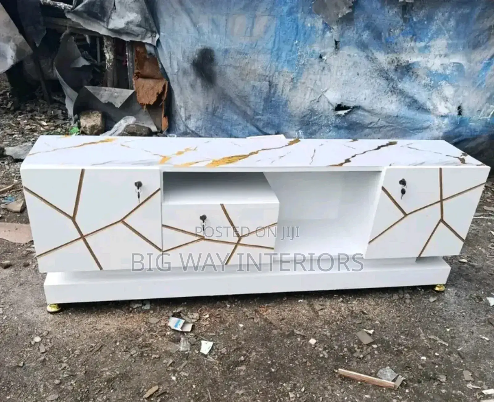 White Flat Tv Stand With a Sticker on Top