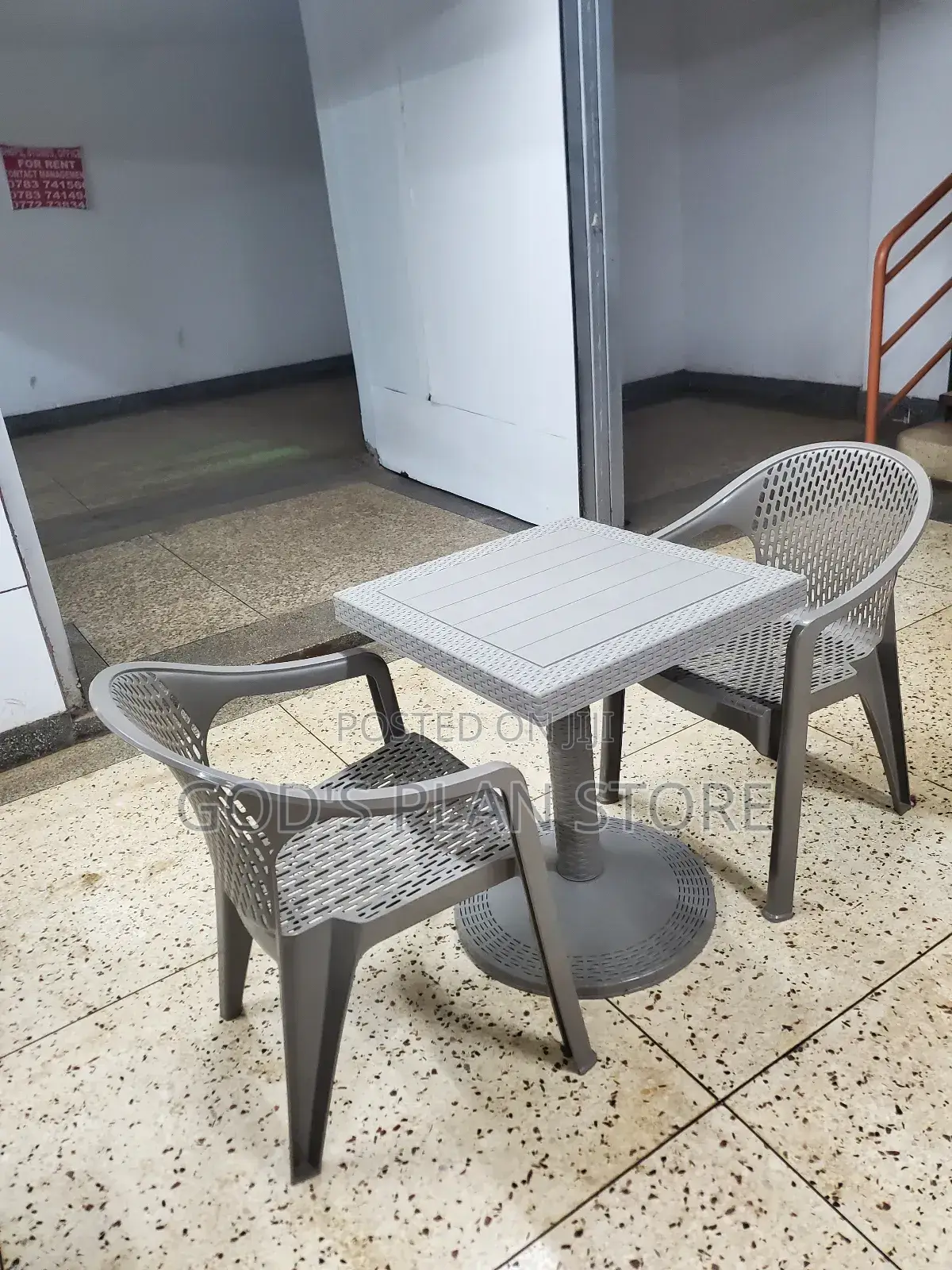 Armed Plastic Chairs and Table 2 Chairs