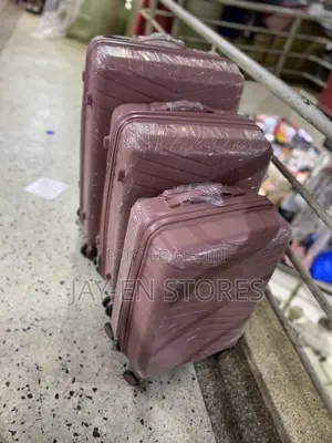 A Set of 3 Rubber Pink Suitcases