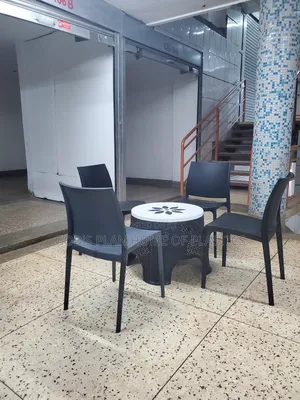 Photo - Portable Plastic Chairs and Center Table