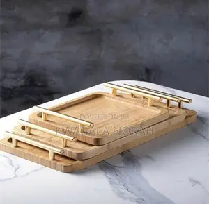 A Set of 3 Bamboo Trays With a Gold Handle