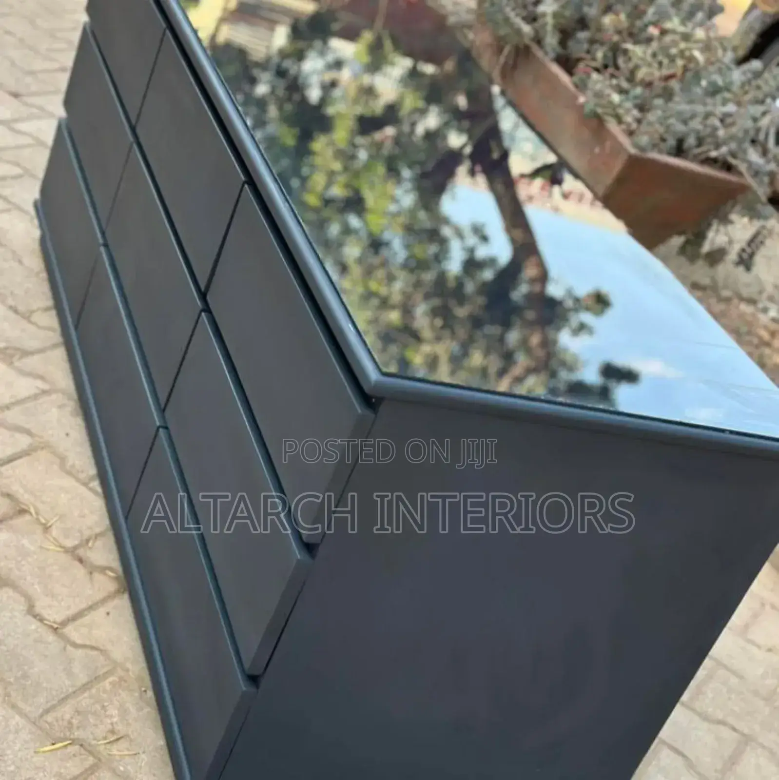 Chest of Drawers in Dark Grey and a Glass on Top