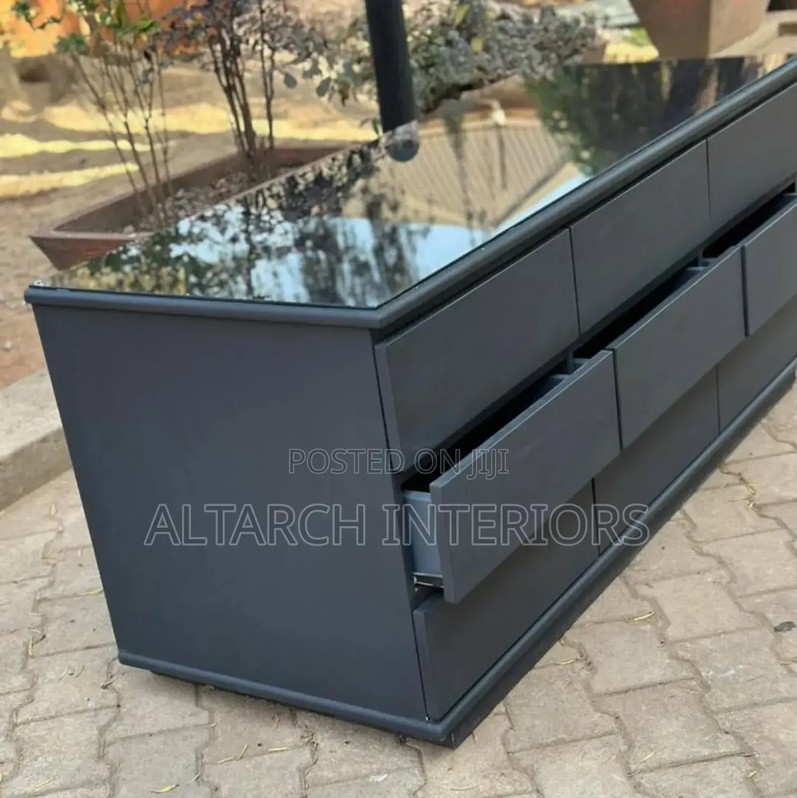 Chest of Drawers in Dark Grey and a Glass on Top