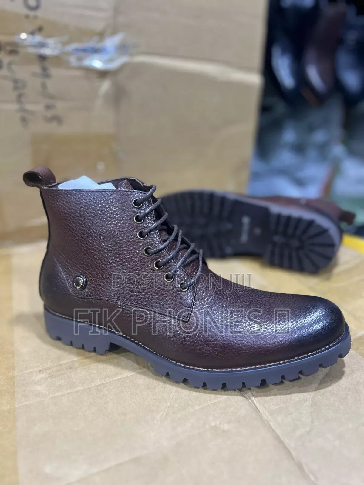 This Is a Pair of Brown Leather Lace-Up Boots With a Rugged Sole.