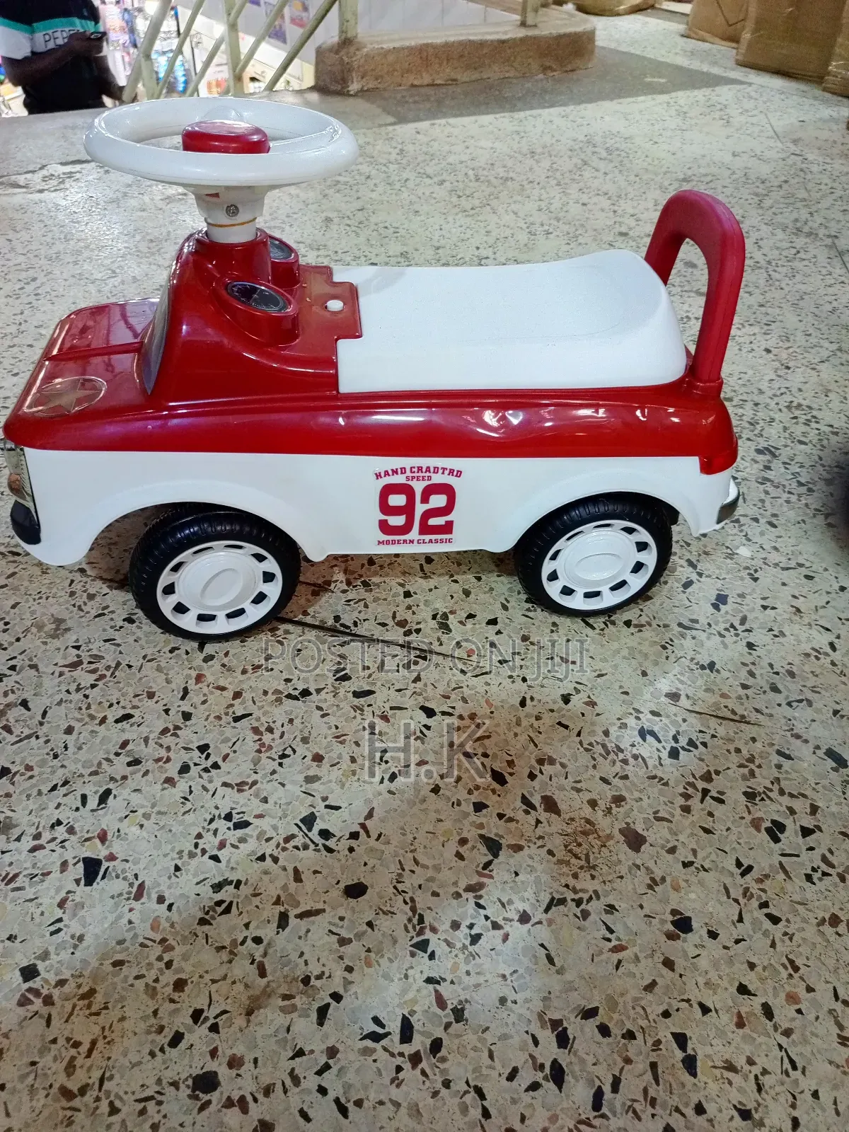Red and White Ride-on Toy Car for a Child.