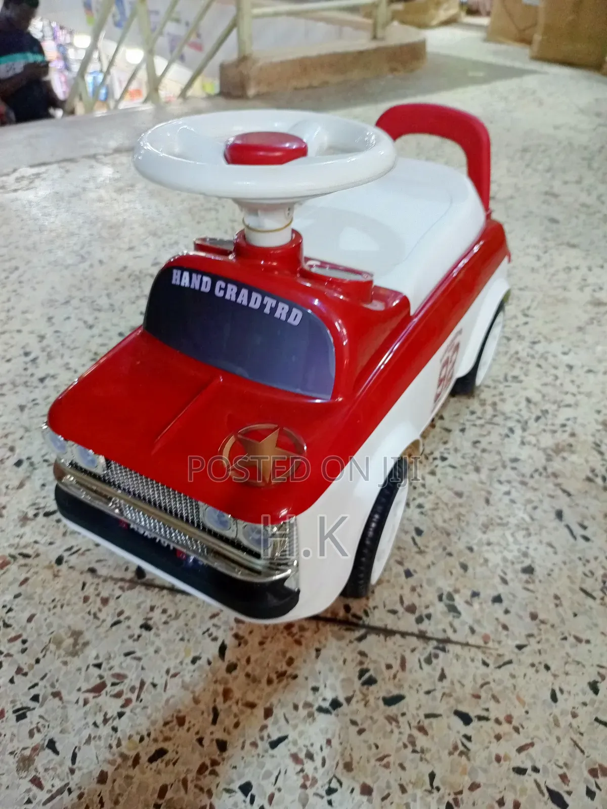 Red and White Ride-on Toy Car for a Child.
