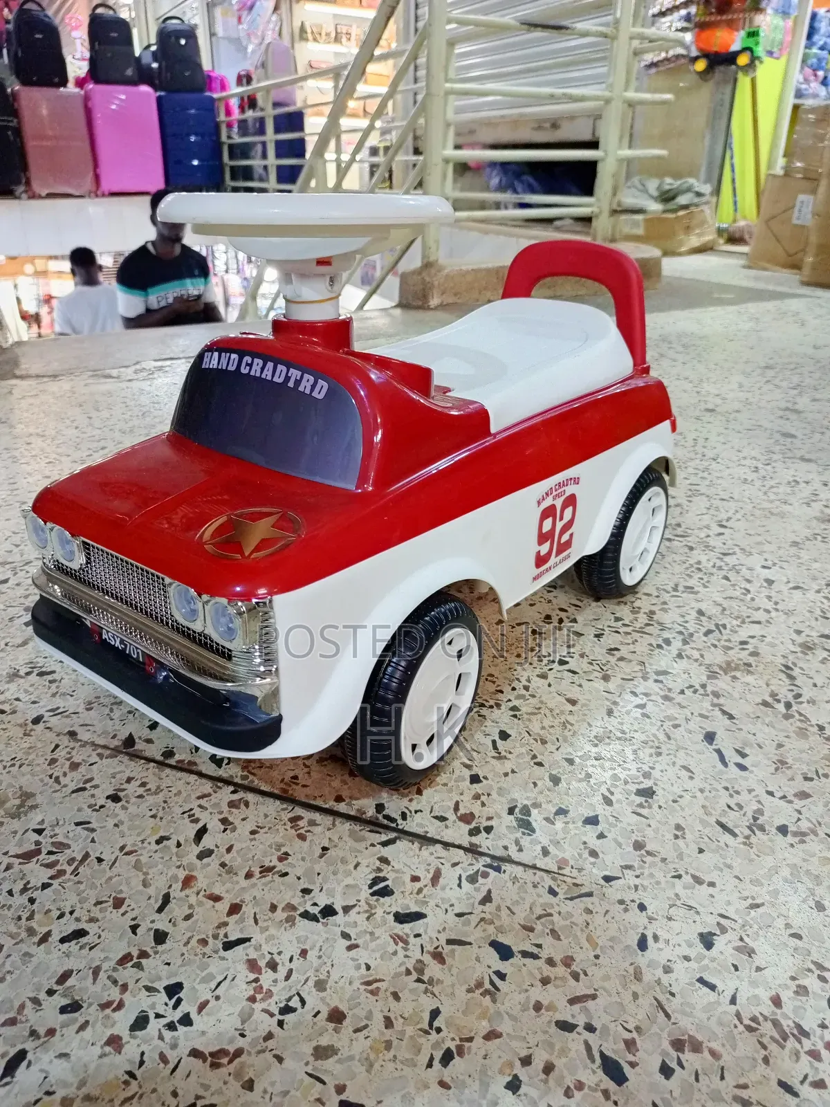 Red and White Ride-on Toy Car for a Child.