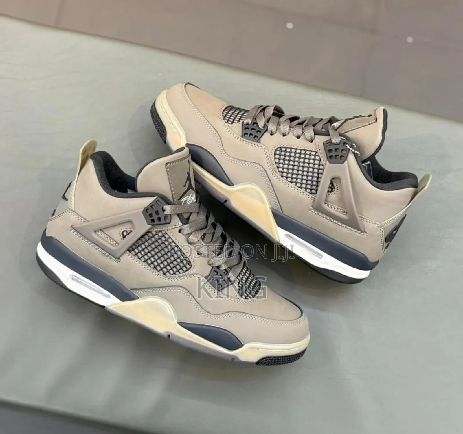Air Jordan 4 Retro "Cave Stone and Black" Sneakers.