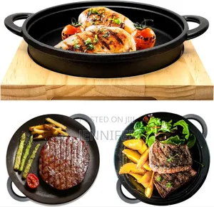 Cast Iron Sizzler Pan With a Wooden Serving Board