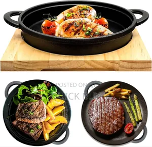 Cast Iron Sizzler Pan With a Wooden Serving Board.
