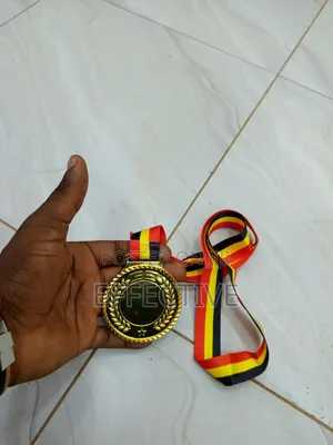 Gold Medal With a Red, Yellow, and Black Ribbon