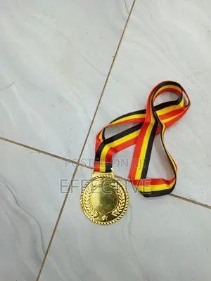 Gold Medal With a Red, Yellow, and Black Ribbon