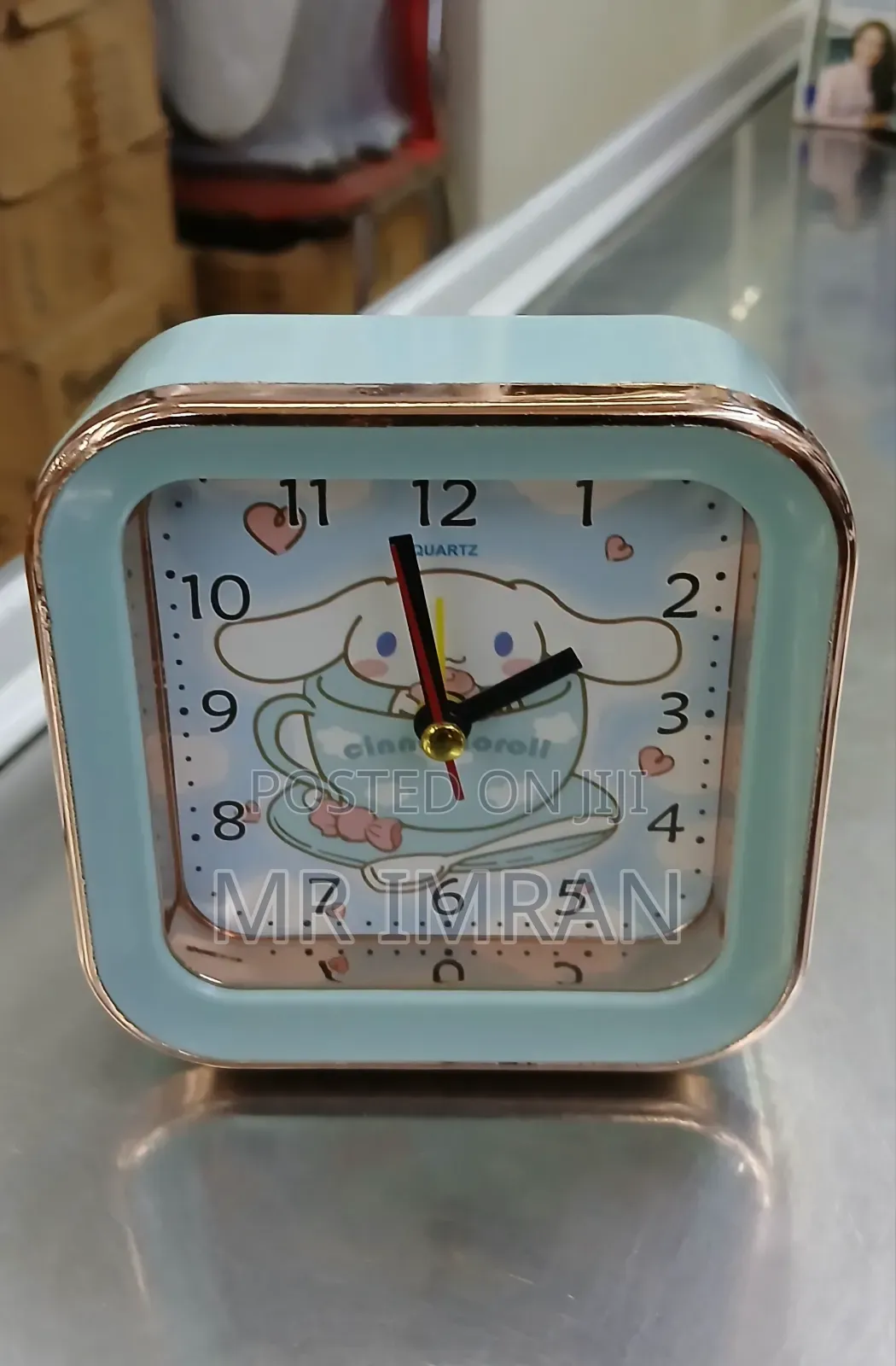 Alarm Clock With a Light Blue and Rose Gold Frame
